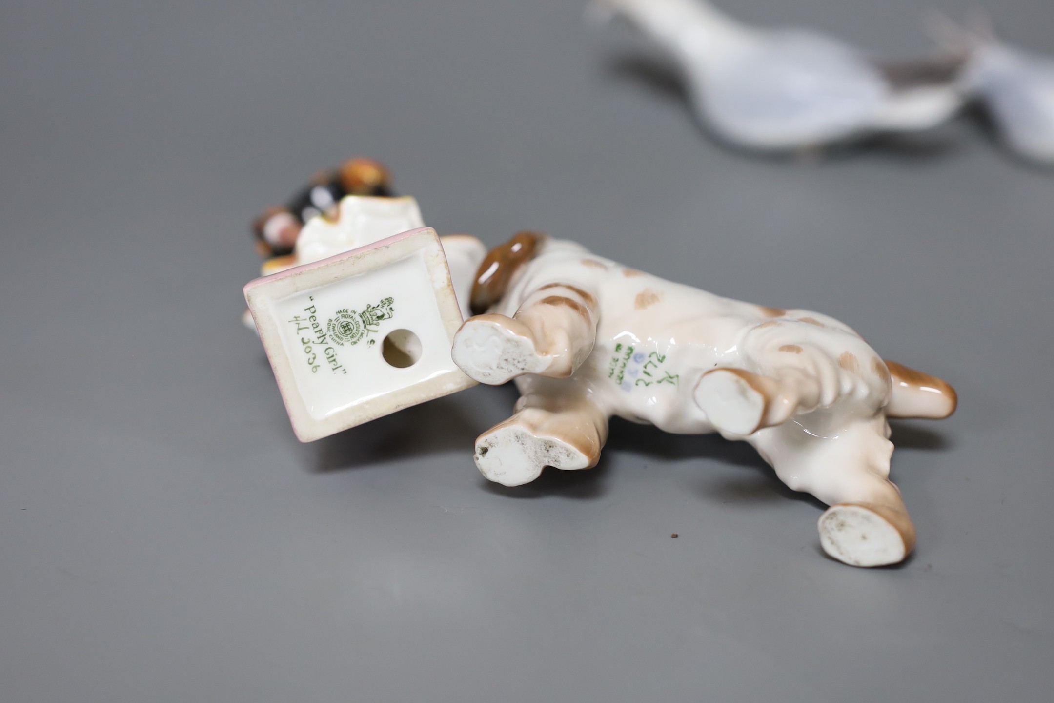 A Royal Doulton figure,”Pearly Girl”, HN 2036, two Bing and Grondahl birds and a dog, figure 14 cms high
